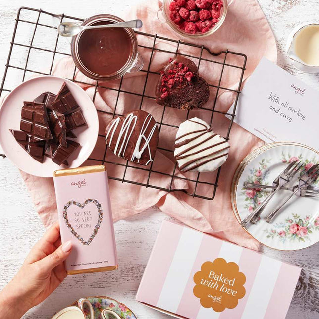 Chocolate heart treats and gift box from Angel Delivery on a decorative table setting