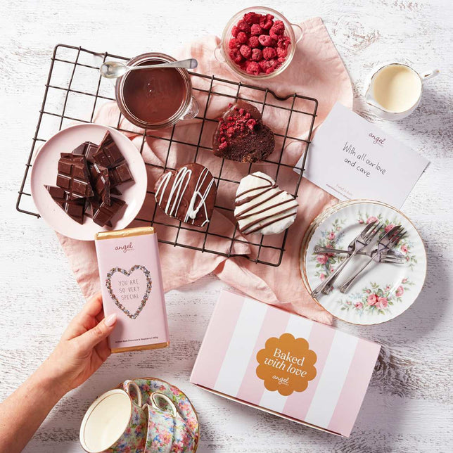 Chocolate heart treats and gift box from Angel Delivery on a decorative table setting